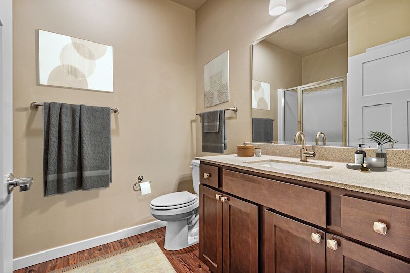 Bathroom with wood vanity and walk-in shower