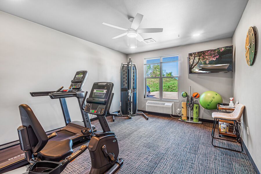 Fitness room with treadmill, recumbent bike and elliptical